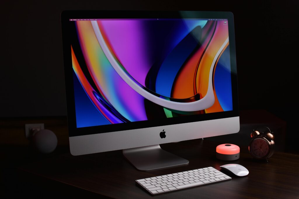 Modern Apple desktop setup with vibrant display and accessories, perfect for tech-savvy professionals.
