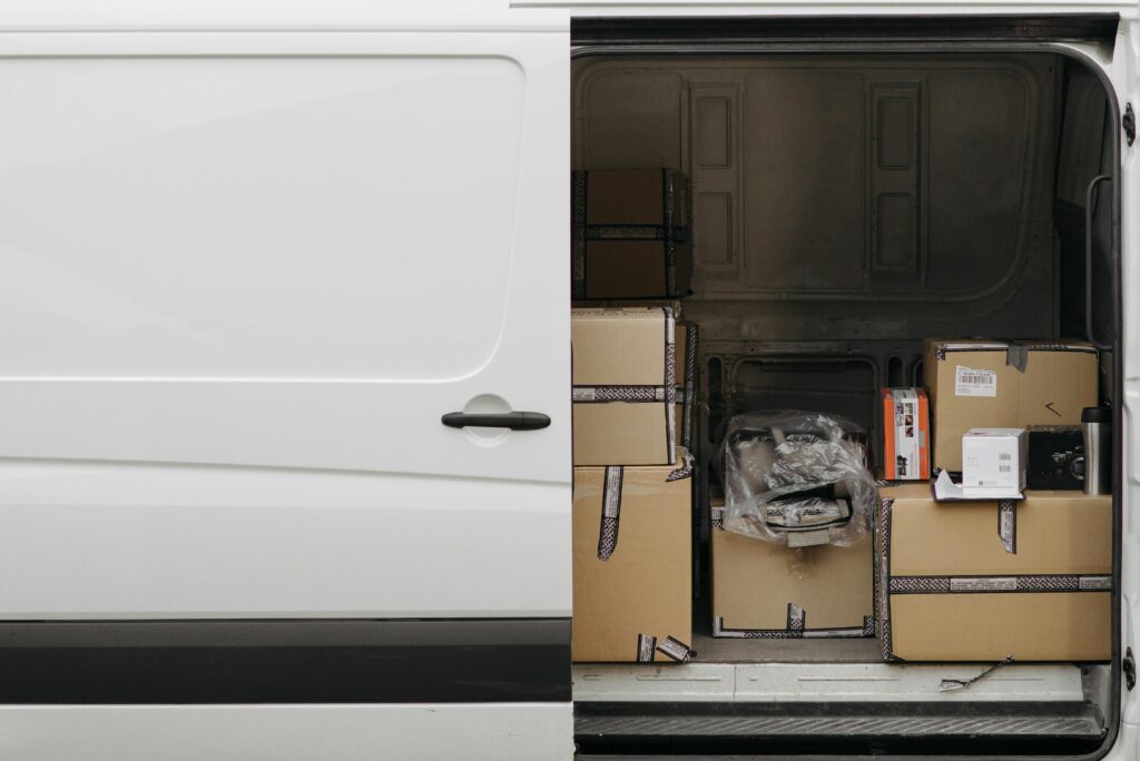 Open delivery van filled with boxes, ready for logistics and transport services.